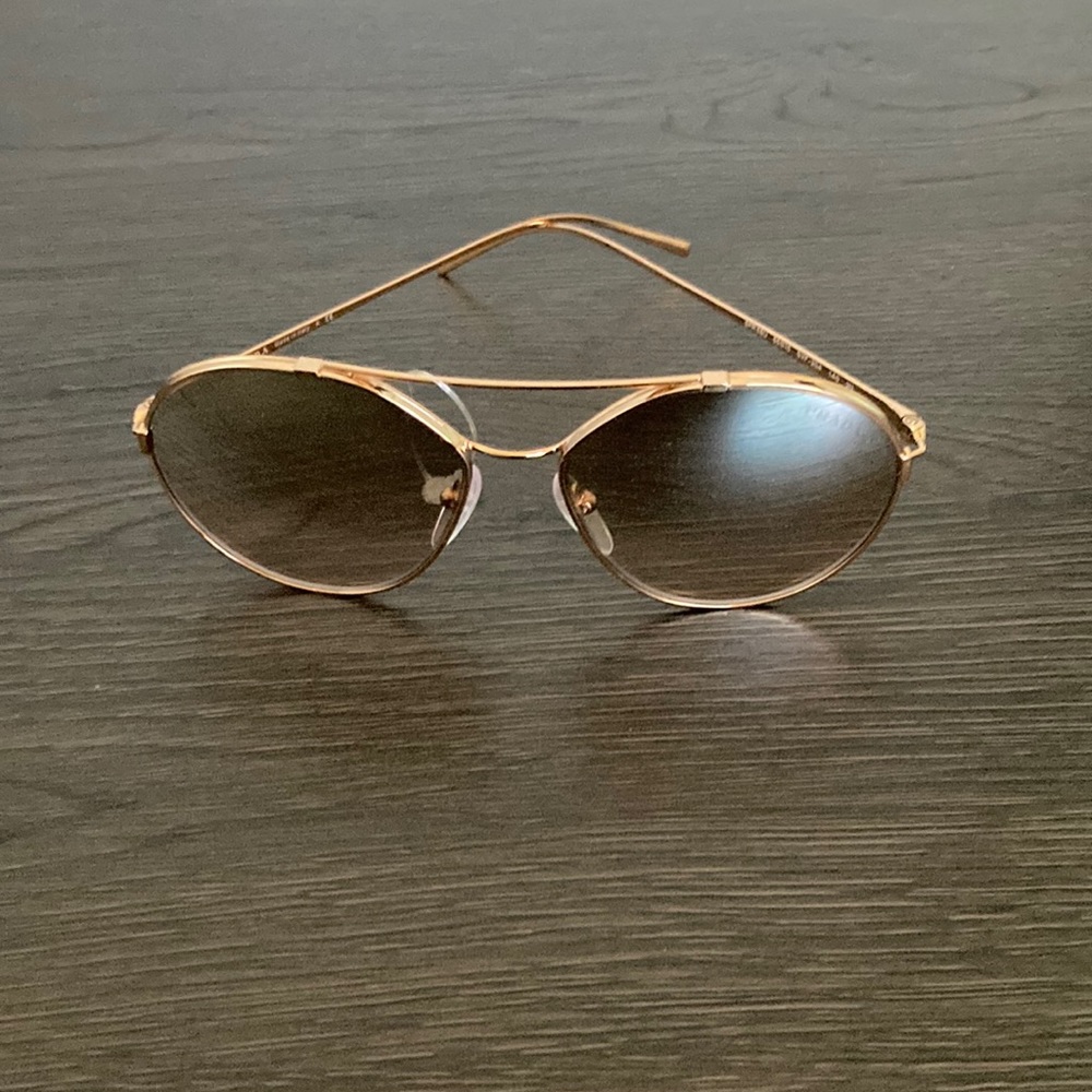 Prada sunglasses. Never worn. Comes with case and bag. SPR 56U